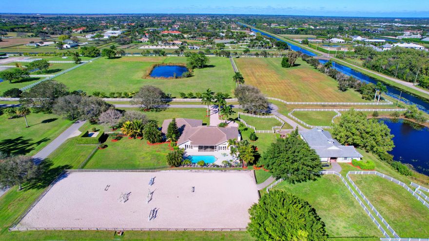 A five acre parcel, roughly 1.25 mile hack to the showgrounds. Located in gated Palm Beach Point, this property boasts a one-story house with 5 bedrooms, 5 full baths including a self contained efficiency apartment with separate entrance, driveway and parking. The screened patio overlooks the open pool deck and sand ring (approx. 92' x 220'). The 6-stall, center aisle barn has a separate driveway, 2 covered and 1 open wash racks, feed/tack room, owner's lounge and full groom's apartment with kitchen/living room, bedroom and bath. 6 paddocks. Pool resurfaced in 2019. New roof on house in 2016 new barn roof 2023. Pond will be filled in.