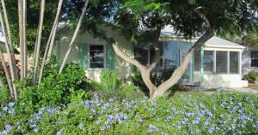 2 homes on one lot! A 2 Bedroom 1 bath home in Parrot Cove with a 1 bedroom 2 bath cottage in the back(yes the cottage has 2 baths), separated by a privacy fence. Yes this home has hardwood floors , fireplace and the charm you are looking for. It does need a new owner with a little imagination and updating.This can be the place of your dreams, in the area you've been looking in. Close to town, golf, beach and everything else Lake Worth has to offer .