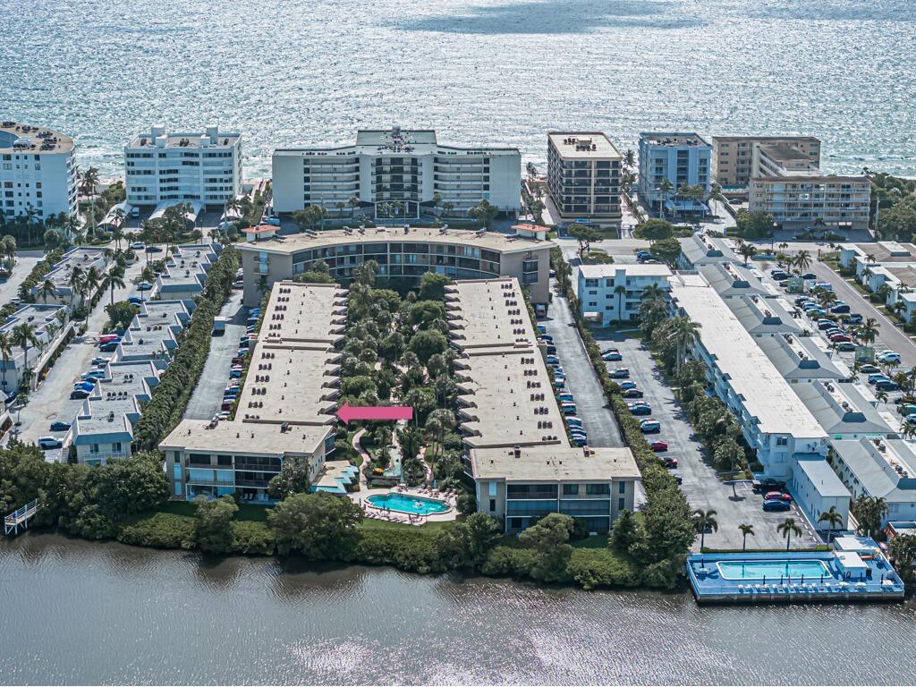 Spectacular, Fully Renovated & Immaculate Unit with Stunning Southern Views! Enjoy breathtaking views of the water, pool, and lush gardens from the expansive screened-in balcony of this beautifully upgraded unit. Completely remodeled in 2023 with high-end finishes, this home features a brand-new AC, impact windows, and elegant diagonal tile flooring. The light, modern kitchen boasts sleek cabinetry, new appliances, a granite backsplash, and a wine cooler. Spacious Scandinavian-inspired bathrooms and a full-size washer and dryer add both style and convenience. A true must-see! This well-maintained Soutgate community offers a serene garden retreat, an Intracoastal-front pool, a sauna, and BBQ area. Enjoy deeded beach access just across the street and shopping and dining close by.