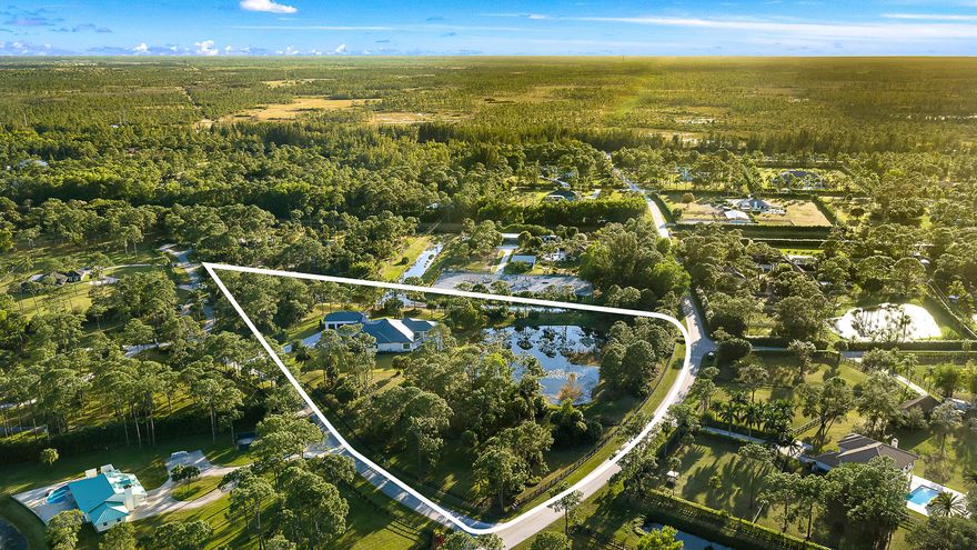 Set within a private estate community of spacious homesites and custom residences, this new construction home spans 6.51 acres, offering privacy, scale, and presence. The home features a modern floor plan with a clean, timeless design. Multiple interior spaces flow to a large covered and open-air outdoor patio with a summer kitchen, built-in speakers, and a heated saltwater pool & spa for seamless indoor-outdoor living. The rear grounds overlook a tranquil pond, with plenty of surrounding green space. A detached four-bay garage with lift-height ceilings connects via breezeway.
Flexible for a full equestrian estate or private retreat, the property also allows for a guest quarters or private office. Short hacking distance to the 30-acre community equestrian park, 32 miles of bridle trails, and nearby stables, and just miles to shopping, dining, golf, and beaches.

Additional features include full-house reverse osmosis (RO) water system, buried propane, generator hookup, spa-style primary suite, all ensuite secondary bedrooms, dedicated office, and a spacious media/recreation room. Full details list available.