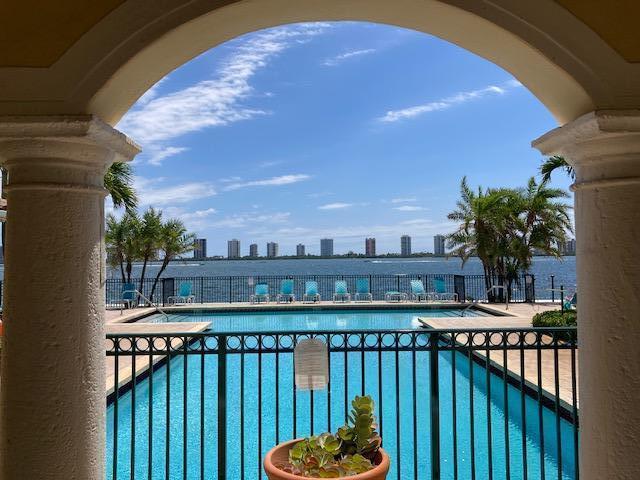 Resort Style Living in an amazing gated community on intracoastal. Freshly painted 2 bedroom 2 bath with newer updates throughout. all tile on first level of living area and bedroom. Large upstairs master bedroom walk in closet newer sink and beautiful vanity. cathedral ceilings. This unit is like a townhome with southern exposure and a beautiful tiled balcony and one car garage. New ac unit, new washer and dryer, S/S appliances & granite counters. Clubhouse on intracoastal with fitness center, pool, jacuzzi,& beach lounge area. Conveniently located within walking distance to shopping & great restaurants or a quick drive to beach, palm beach gardens mall, whole foods, trader joe & NPB CC. Minutes to major highways & airport No Smoking in unit, balcony or garage.Master bedroom upstairs.