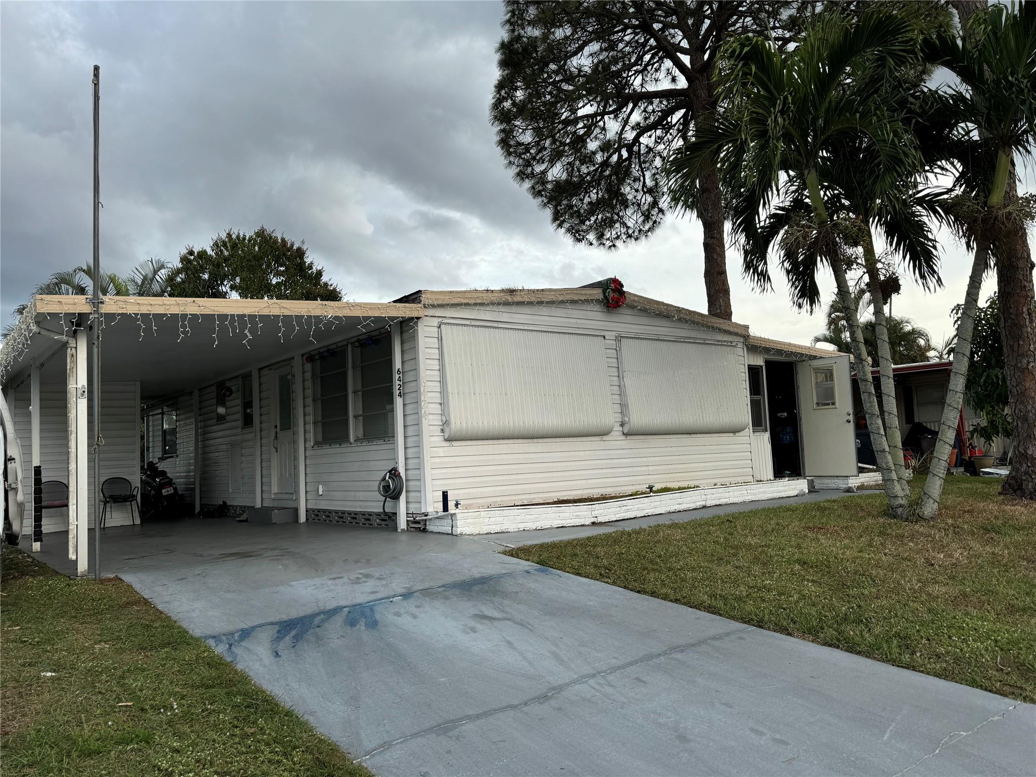 JUST LISTED! 2/2 with attached laundry room and enclosed porch. Needs some TLC. Ample living areas. Gated 55+ community. This community has two pools, clubhouse, fitness room, game room, kitchen, library , bocce, tennis courts and so much more. Sellers motivated. Great location. Land lease.