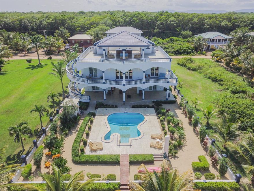 A rare beachfront estate with private marina in Hopkins Village, Belize. The property functions as a private residence, luxury rental retreat, or income producing compound perfect for weddings or private events. This fully furnished 7 bed, 8 bath compound includes multiple individual suites, direct Caribbean beachfront, private marina with 2 boats on lifts, a main residence, two boathouse suites, a caretaker's suite, 360 Degree rooftop terrace, and a guitar shaped pool. The estate is fully furnished and designed for flexible use whether it be a private residence or a luxury rental. The property comes fully furnished and also includes 2 Boats, a Jeep, and water toys.