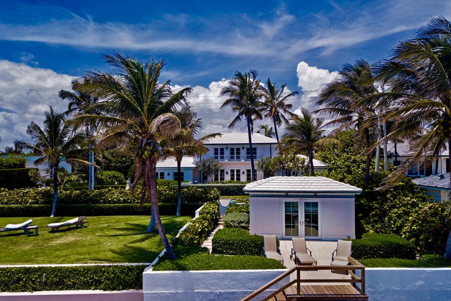 Classic, elegant Bermuda beach house   with great ocean views, a private beachfront cabana and separate guest cottage.  Flowing commodious rooms with  soaring ceilings grace the home. Impact French Doors open to an abundance of terraces overlooking the ocean to the east and private pool to the west. Amenities include a 48 Ft lap pool, library, fireplace, family room,  and 3 car garage  This inviting property is beautifully landscaped and well maintained . Its a rare island paradise at the edge of white powder beaches and the ocean's epic beauty... on the North end of Palm Beach. Outstanding beachfront value.