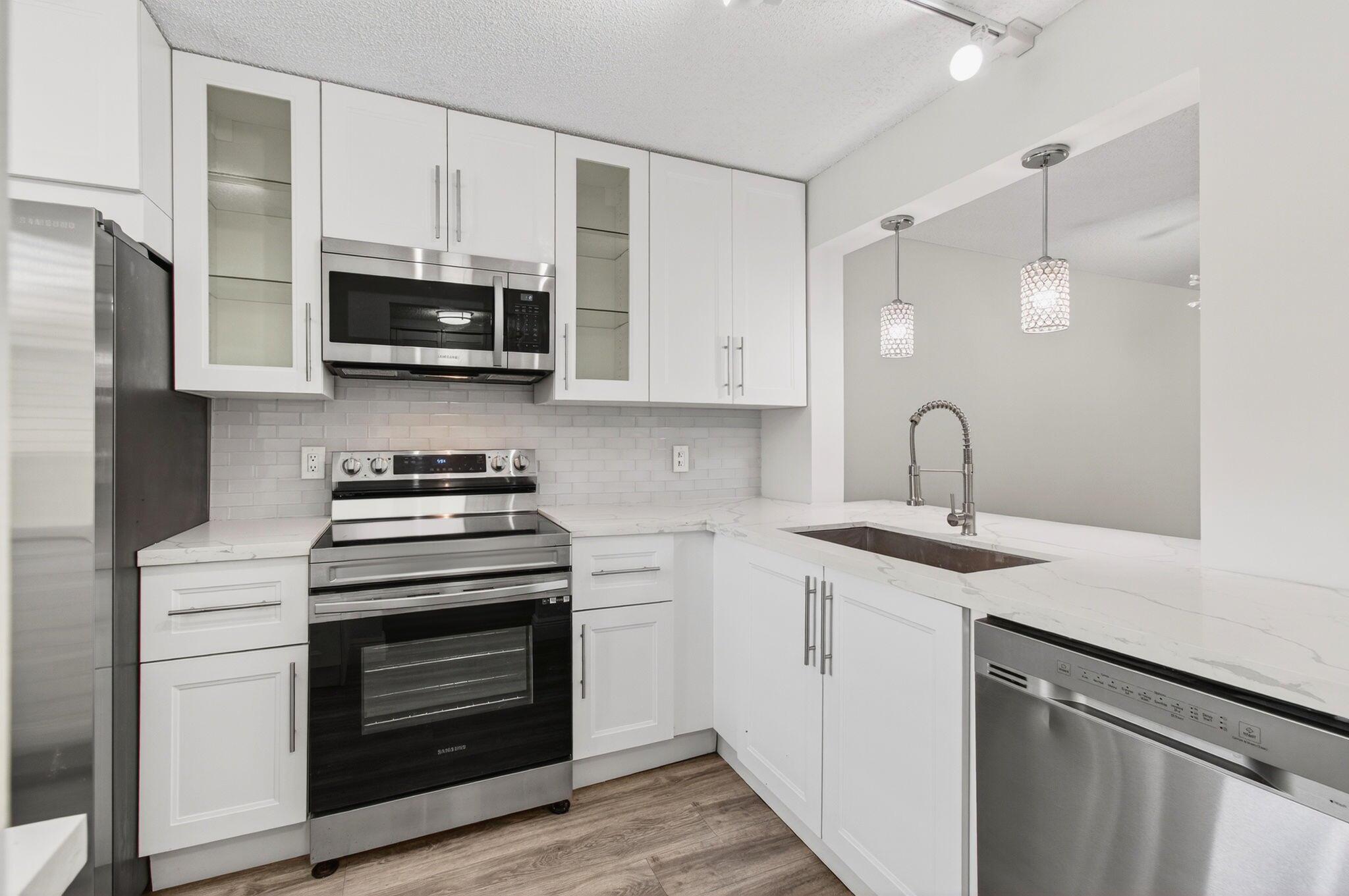 Beautiful 2 bedroom, 2 bath GROUND FLOOR condo with covered parking just steps away from your front door. Newly renovated and freshly painted (Sept. 2025). Screened patio overlooking a large green space ... total privacy!