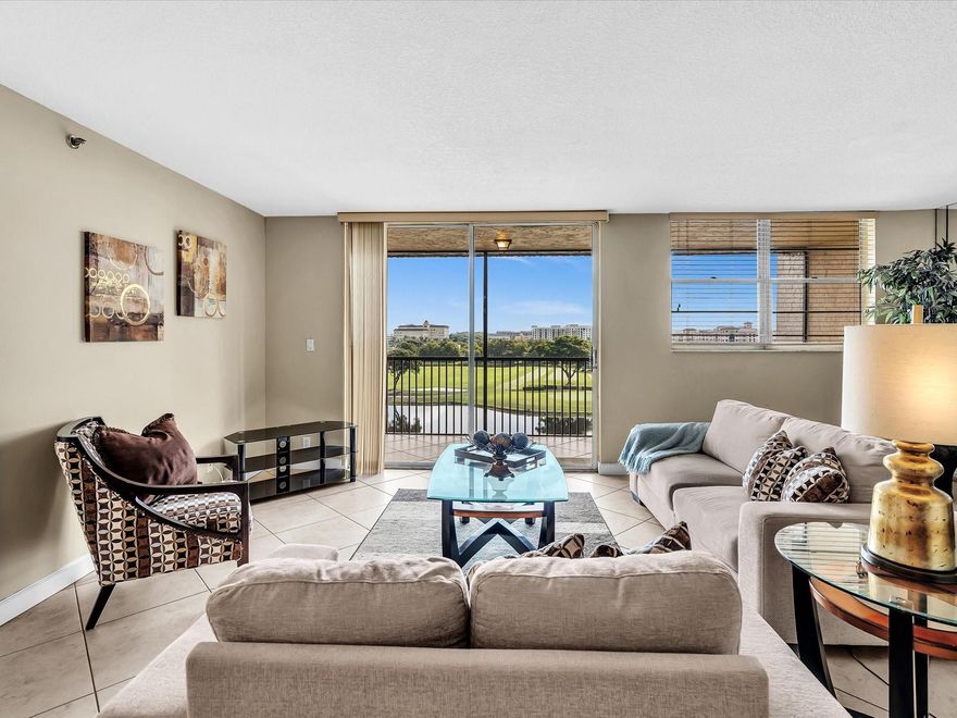 Experience elevated living in this beautifully updated 2-bed, 2-bath condo overlooking serene lake and Grande Oaks Golf Course views. Flooded with natural light, this move-in-ready home features tasteful upgrades and comes fully furnished—just bring your suitcase and start enjoying the Florida lifestyle!Enjoy peaceful mornings on your screened-in patio, taking in the sunrise over the greens, and relax in a space that blends style, comfort, and convenience. Perfect as a seasonal getaway or full-time residence, this turnkey gem is ideally located near NSU, Tower Shops, and major highways (I-595 & TP) Don't miss your chance to own this rare top-floor retreat!