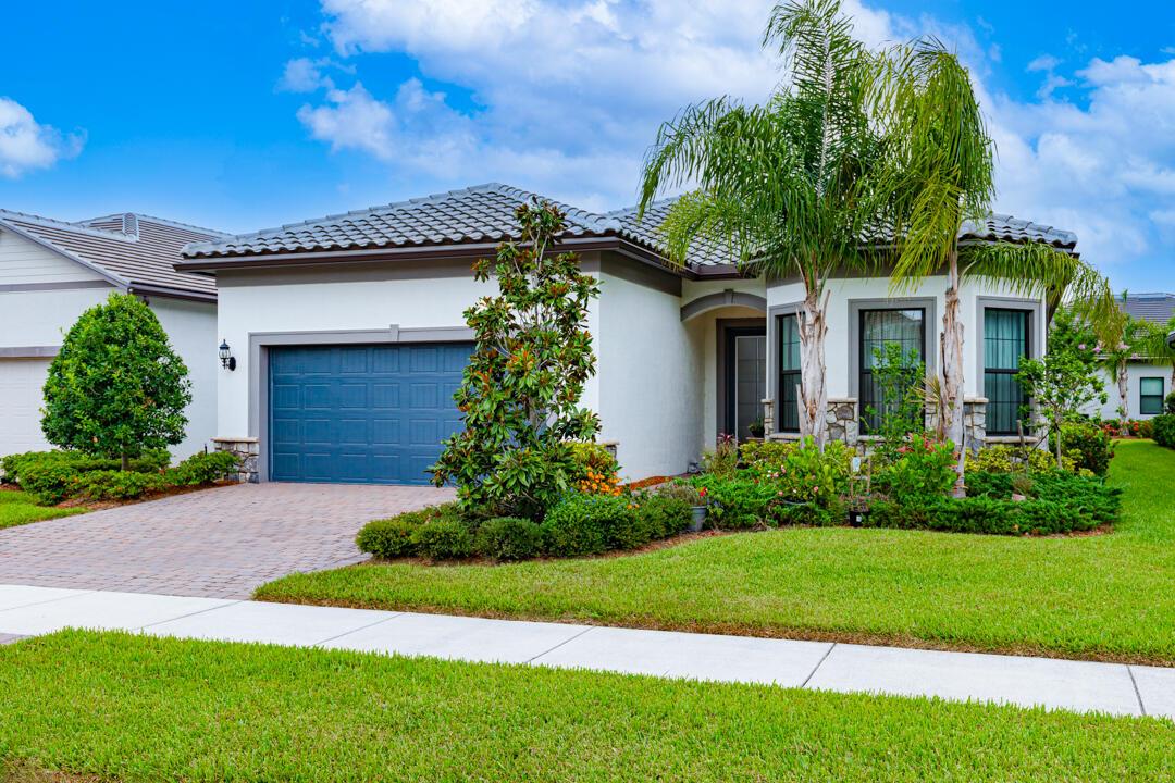 ***Stunning*** REDUCED*! 3-bed, 3-bath plus den/office w/French Doors spanning 2,224 sq ft is designed for comfort and elegance in gated Veranda Gardens. The expanded gathering room w/hardwood floors, crown molding, extra lighting and remote Hunter Douglas blinds is the heart of the open concept home. Gourmet kitchen features KitchenAid wall oven, microwave and hood, GAS cooktop, large island w/convenient end storage, quartz countertops, stylish backsplash, and elegant lighting fixtures. Enjoy peace of mind w/full IMPACT glass, ceiling fans, smooth-finish walls, 8-foot interior doors, designer front door and brick facade. Extended screened lanai invites seamless indoor-outdoor living with partial lake views and fenced yard. Move-in ready home combines modern luxury with attention to detai