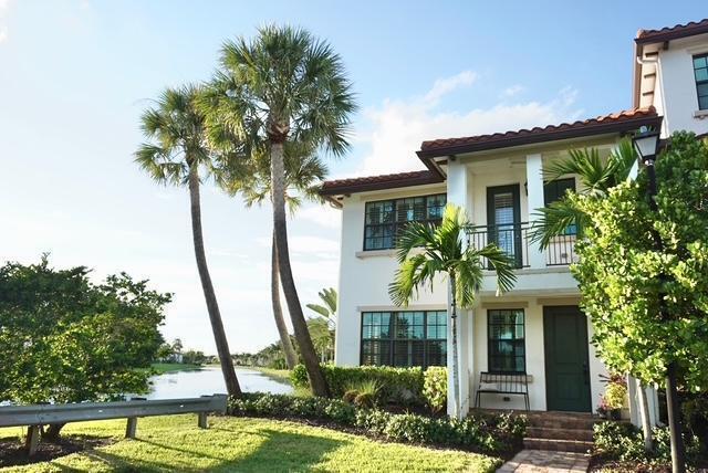 THIS IS THE ONE!! Beautifully updated 3 BR/3.5 BA townhome with over 2000 sq. ft. of sun lit, open living. The bright kitchen flows into open dining & living areas with added recessed lighting, luxury vinyl floors, & plantation shutters throughout. Model features a spacious 2.5 car garage, oversized primary suite w/balcony, and full ensuite baths for each bedroom. Recent appliance upgrades include a 2023 LG Smart washer/dryer, and 2024 Whirlpool dishwasher & microwave. Rare corner lot with only one neighbor & water backdrop, just steps to pool, clubhouse & gym!! Gated Raintree Community just minutes to shopping, dining, and parks!!