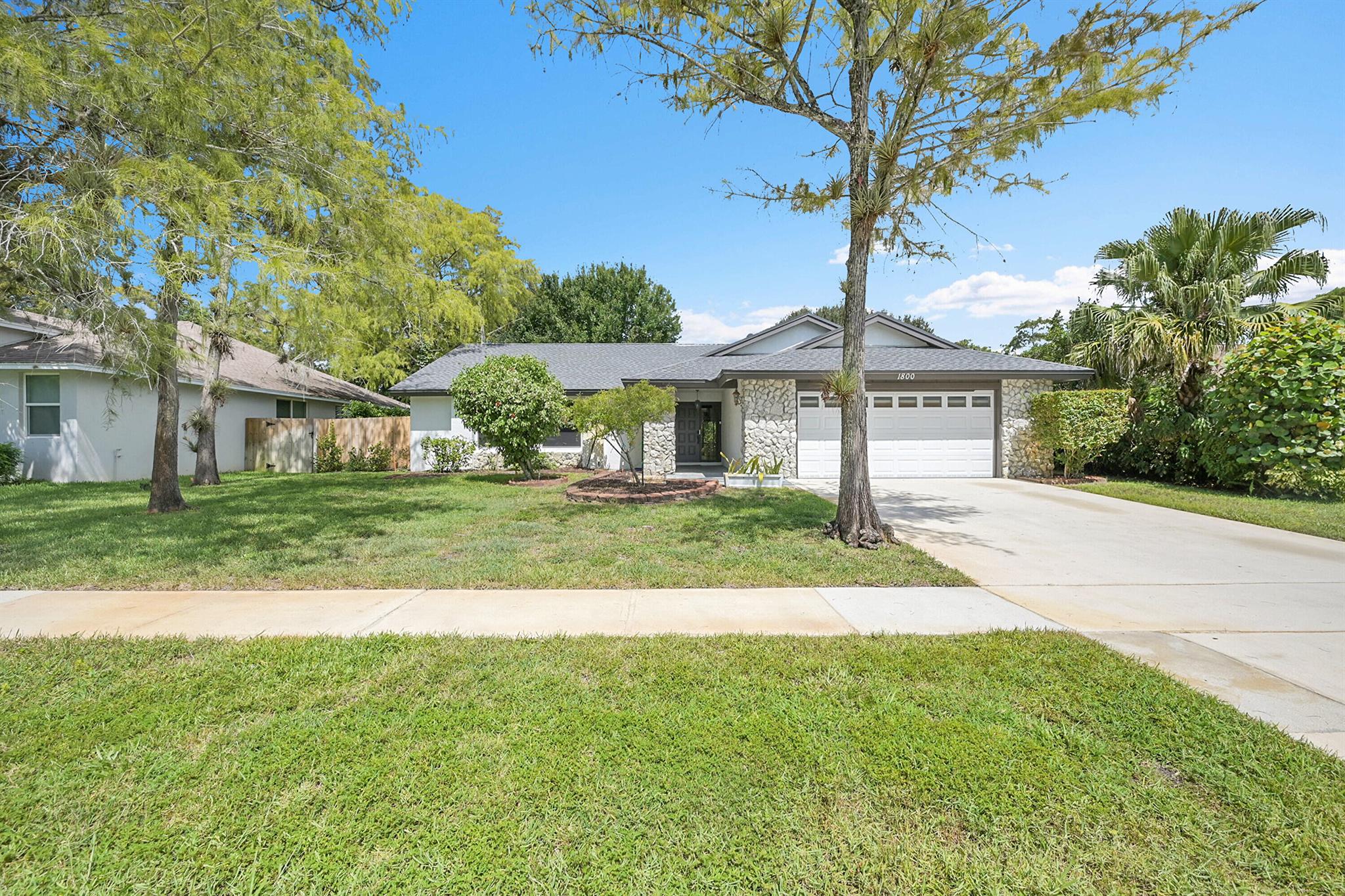 AVAILABLE NOW! Spacious and updated 3-bedroom, 2-bathroom home with a large fenced backyard. This single-story home features a bright and open floor plan with vaulted ceilings, tile flooring throughout, and a large kitchen equipped with stainless steel appliances, granite countertops, and ample cabinet space. The primary suite includes a walk-in closet and a private en-suite bathroom, while the additional bedrooms provide plenty of space for guests, family, or a home office. Outside, enjoy a fully fenced backyard perfect for relaxing or entertaining. Additional features include a 2-car garage, interior laundry with washer and dryer included, and fresh paint throughout. Located in a quiet neighborhood (Sugar Pond Manor) and zoned for A-rated Wellington schools.