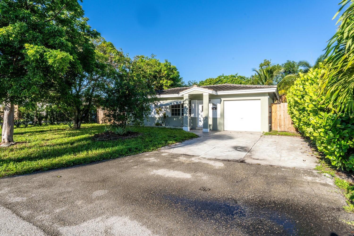 Excellent opportunity to own a single-family home in the heart of North Andrews Gardens! This 2-bedroom, 1-bath home with a 1-car garage sits on a 5,803 sqft. lot and is loaded with potential. Built in 1953, the property features concrete block construction, ceramic flooring, and a one-story layout with first-floor entry. W/D hookup and plumbing in place for a 2nd bath. Enjoy outdoor living with a fenced yard, multiple fruit trees, including mango, avocado, tamarind, and cashew, and plenty of space for a pool or other enhancements. The Florida room opens through French doors to the backyard. Located in a desirable neighborhood near the airport, the beach, major roadways, restaurants, and Downtown Las Olas, where you’ll find shopping, world-class dining, art galleries, nightlife, and more!