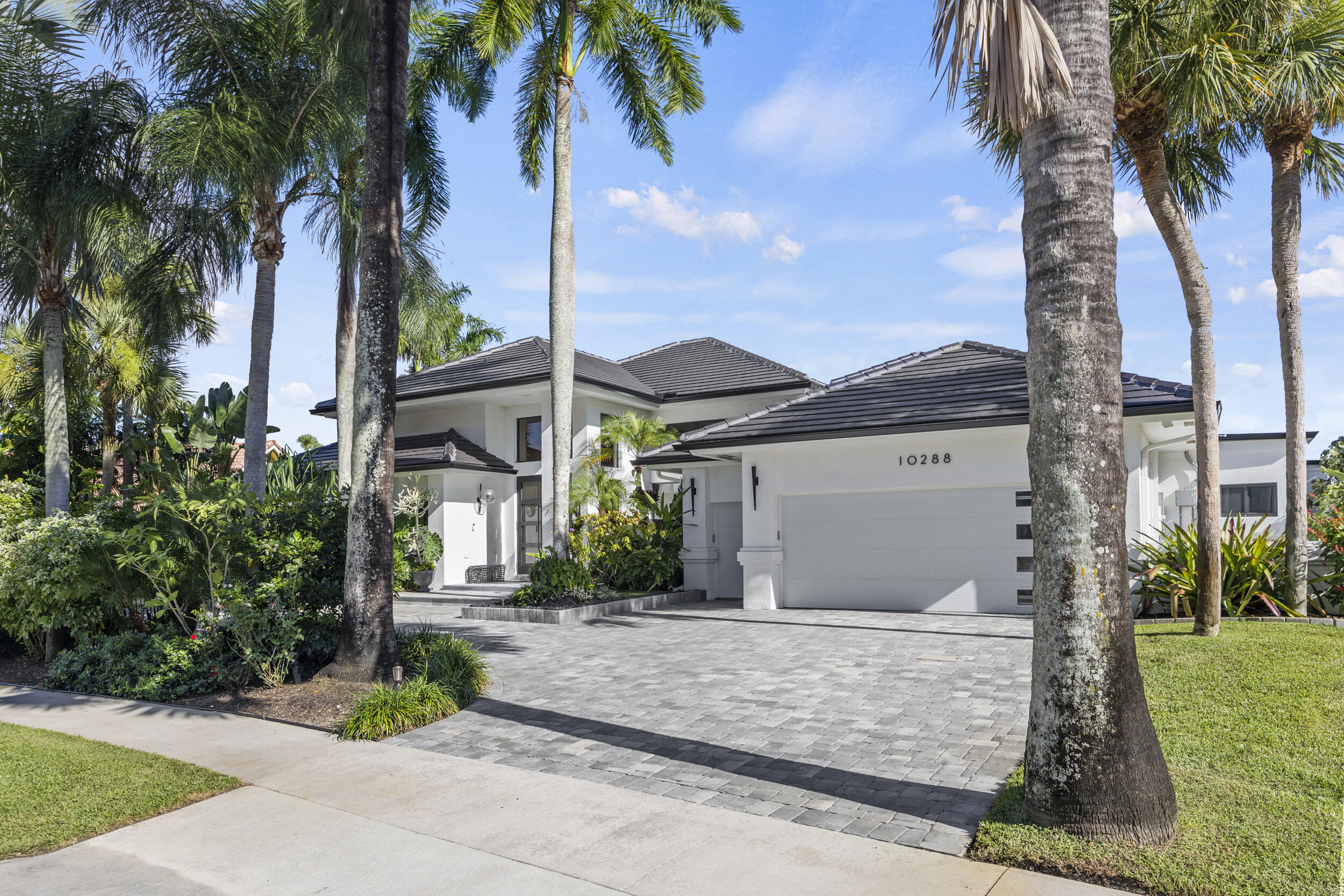 Step into a world of unparalleled elegance and luxury, where every detail has been artfully designed. This exquisite 4bd/4.1ba home has been completely remodeled with the finest designer finishes, blending sophistication and style at every turn. The kitchen, a masterpiece in itself, boasts high-end cabinetry, top-tier appliances, and a striking accent wood ceiling that extends seamlessly into the family room, complete with custom built-ins and a large wine refrigerator for the discerning connoisseur.Gleaming porcelain floors guide you through this stunning home, enhanced by tastefully designed accent walls and lighting that create an inviting atmosphere throughout. The primary suite is a sanctuary of serenity, featuring a (click 'more')
