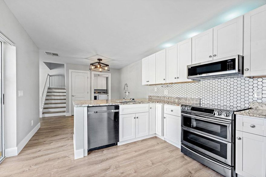 A charming renovated 2-bedroom townhome nestled in the sought-after gated community of Wellesley at Lake Clarke Shores. Bright, airy, and move-in ready, this home impresses with modern finishes and a dual-master layout perfect for privacy and comfort. Step inside to a spacious living area with flat ceilings, new flooring, and an abundance of natural light. The updated kitchen features crisp white cabinetry, stainless steel appliances, a double-door oven, welcoming bar, and a white glass French door refrigerator that complements the clean, modern aesthetic.Upstairs, both bedrooms offer on-suite baths, walk-in closets with built-in storage, creating two true master suites. Additional highlights include accordion shutters, modern fixtures, and thoughtful design details throughout.