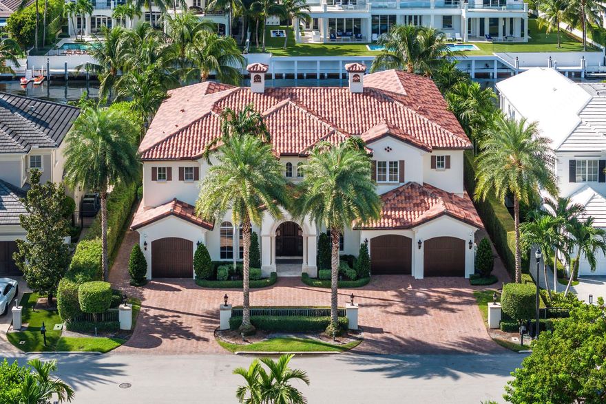 Enjoy this exceptional opportunity to live in Boca Raton's most prestigious community, Royal Palm Yacht & Country Club, where luxury meets waterfront perfection. This 5-bedroom SRD Signature Estate boasts contemporary design and impeccable custom finishes. As you enter through the solid mahogany door, imported marble flooring guides you to breathtaking waterway views. The first floor features a gourmet kitchen with top-of-the-line appliances, a bar-equipped clubroom, and a family room seamlessly connecting to the outdoors. Upstairs, the master suite awaits with its own morning bar, His & Her spa-like baths, boutique closets, and a balcony overlooking the spectacular grand canal. Four additional guest suites, a loft-style living room, and a spacious wrap-around balcony complete the
