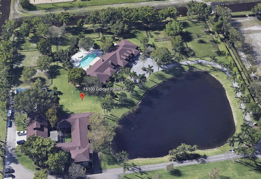 This gated Palm Beach Point property sits on 10+ acres and has it all! The main home features 5 bedrooms and 4-1/2 bathrooms. There is a 2 bedroom, 1 bath apartment attached to the house that comes complete with a full kitchen and living area - and has a separate entrance! The saltwater, heated pool is extremely relaxing. There are two barns, totaling 19 stalls. The 13-stall barn has tack and feed rooms, laundry room, a large hay room with roll down door for easy deliveries, an upstairs office with a full kitchen and full bathroom. The 6-stall barn has a groom's apartment, tack & feed room and washer & dryer. Each of the stalls in the barns has the fly spray system. Property also has a 256'x160' riding arena, large grass field and 21 paddocks!