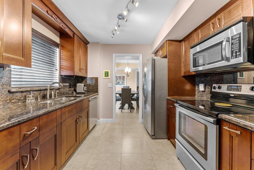 Welcome to this beautifully updated 3‑bed, 2.5‑bath corner residence offering 1,700 sq ft of bright, comfortable living with brand‑new 2025 impact windows and shutters. Step inside to an oversized living and dining area that opens effortlessly to a charming private patio -- the perfect spot for morning coffee, quiet evenings, or relaxed gatherings with friends. The kitchen features granite countertops, stainless‑steel appliances, and a cozy eat‑in area that feels instantly inviting.The separate primary suite is a true retreat, complete with a stunning bath, double‑sink vanity, and a spacious walk‑in closet. A full‑size washer and dryer in the utility room add to the home's convenience. Turnkey options available.