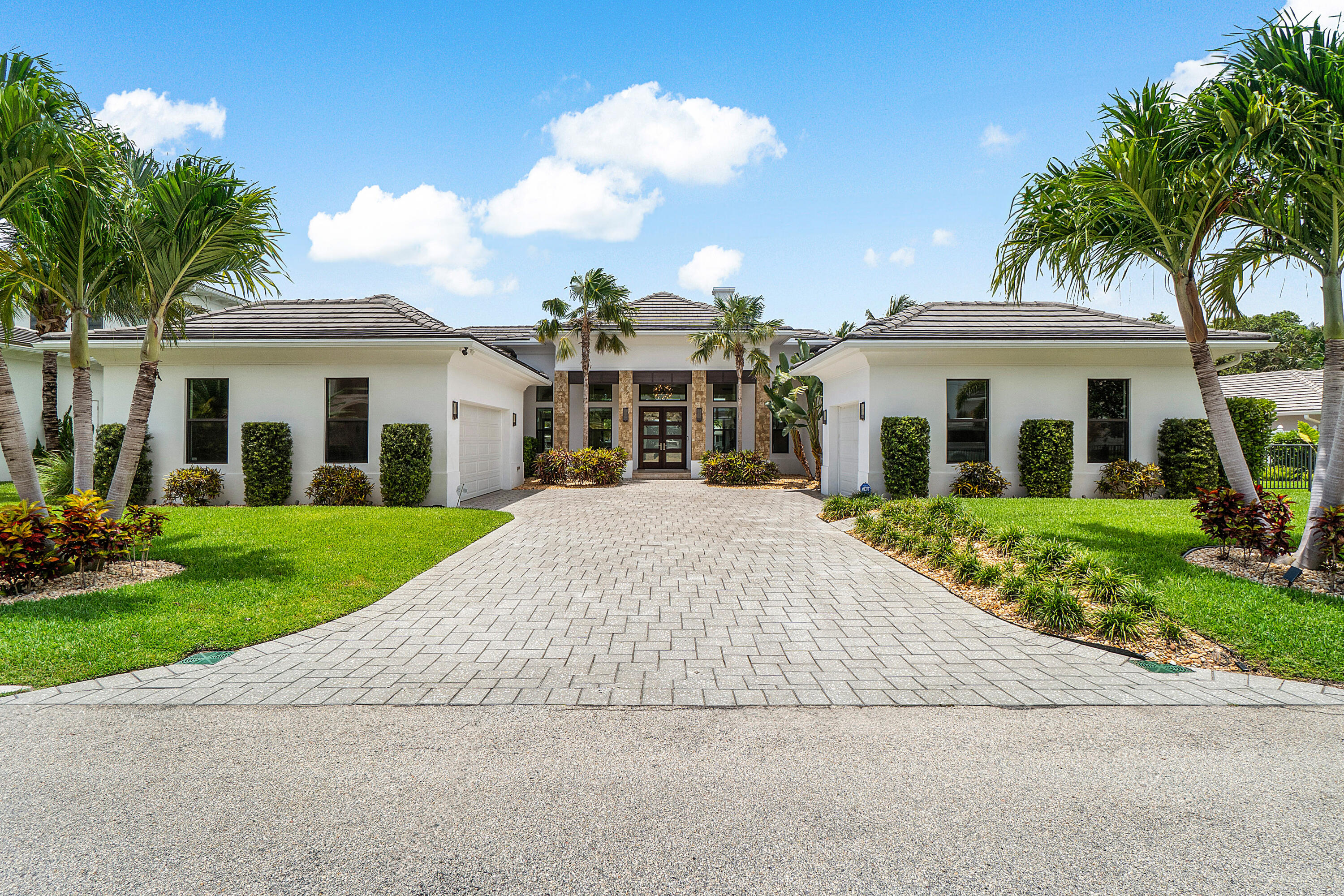 Waterfront Luxury Living in Prime Boater's Location!Welcome to this exceptional waterfront residence offering over 130 feet of deep water frontage just one canal from the Intracoastal. Built in 2017, this custom-designed residence features 4 bedrooms and 4 baths, including a private guest house, all situated on a premium 1/3-acre lot at the widest point of the canal for optimal water views and turning radius.The grand great room welcomes you with soaring 16' ceilings and breathtaking waterfront vistas. Ideal for boating enthusiasts, the property includes 4 slips (36 ft. -30,000 lb. lift , 34 ft. 14000 lb. lift , 55 ft., and a 28' water slip) just a one-minute ride to the Intracoastal.
