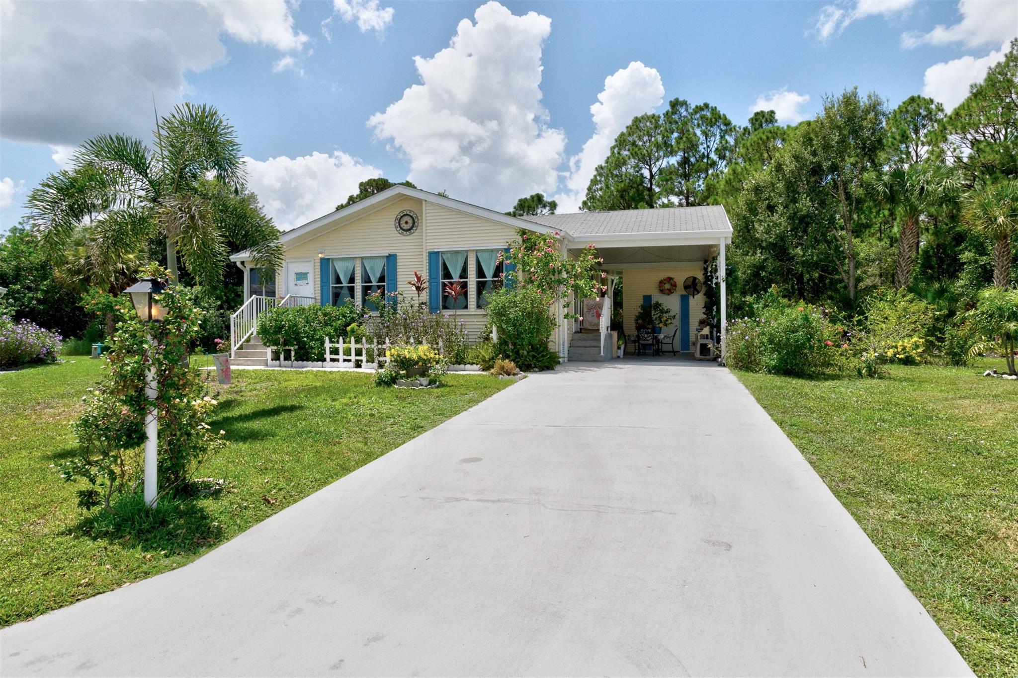 Adorable Artists Home on a double corner lot (only one lot rent) with wooded back yard. A Gardener's dream. this 2/2 will make you want to move in...Heritage Plantation has a clubhouse, pool and much more. Convenient to I 95 and the Indian River Mall area with restaurants and shopping.
