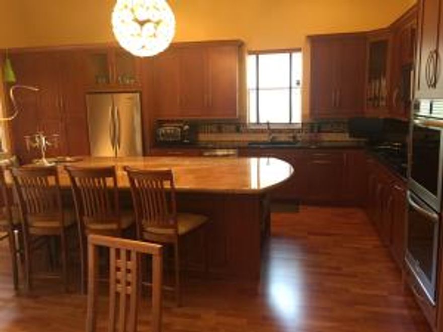 WOW! THIS HOME IS LOVELY AND LIGHT AND BRIGHT AND ALL ON 1 FLOOR! WOOD FLOORING THROUGHOUT LIVING AREAS WITH CARPET IN THE BEDROOMS. A FABULOUS CHEFS KITCHEN WITH WOOD CABINETS AND GRANITE COUNTERS, THE DOUBLE OVENS ARE NEW ALONG WITH THE COOKTOP OF THE GAS COOK TOP, THE A/C AND THE CARPENT IN BEDROOM 3. THIS HOME FEATURES ACCORDIAN HURRICANE SHUTTERS, A SHED AND PORTABLE GENERATOR, AND A SCREENED IN PATIO. THERE ARE ALSO WOOD BLINDS AND THE WALLUNIT IN THE LIVING ROOM IS STAYING!THIS HOME IS A MUST SEE!