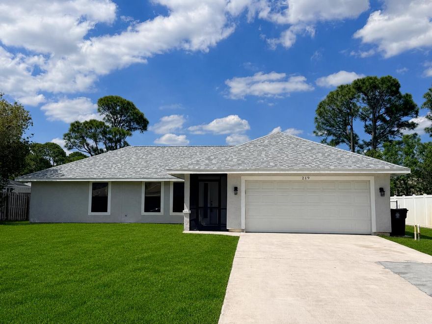 Stunning 3BR/2BA single-family home with a desirable split floor plan and bright open-concept living areas. Spacious screened patio overlooks a large fenced backyard with room for a pool plus convenient boat parking access. Located near a main canal with nearby boat ramp access, perfect for boating enthusiasts. No HOA fees. Features include NEW roof (2025), newer A/C (2021), public sewer, tankless water heater, fresh interior/exterior paint, upgraded bathrooms with tiled walk-in showers, new doors (2026), tile floors in living areas, laminate in bedrooms, walk-in closets, ceiling fans throughout, irrigation well-system, laundry room with washer/dryer, and attached 2-car garage. Large driveway fits 4+ vehicles. Conveniently located in the heart of Port St. Lucie near schools, shopping.