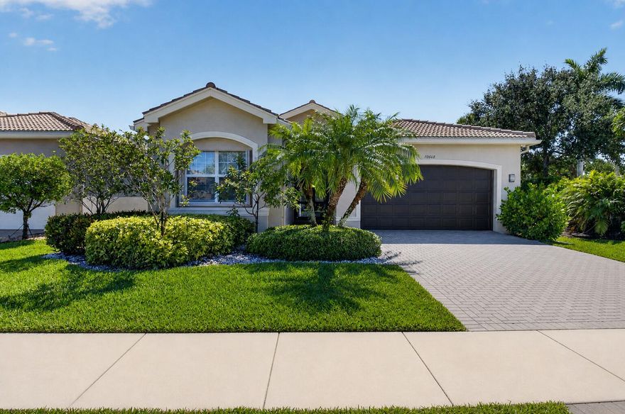 Completely reimagined with high-end finishes and thoughtful upgrades throughout, this two bedroom with den, move-in ready residence offers a seamless blend of modern design and everyday functionality. A hurricane-impact glass front door with a transom window creates a striking first impression, while the freshly painted interior, new vinyl flooring, crown molding, and upgraded trim work carry a cohesive, refined look throughout the home. The fully renovated kitchen serves as the centerpiece of the home, featuring Cambria quartz countertops, skinny shaker cabinetry, and a spacious island with additional storage. It also offers a large pantry with convenient drawer pullouts, while the lower cabinets are designed with deep, full-extension drawers for enhanced accessibility. A premium appliance package includes GE Monogram double ovens, cooktop, and dishwasher, complemented by an XO hood, microwave, and wine refrigerator. Under- and above-cabinet lighting, along with recessed lighting throughout, enhances both ambiance and functionality.  The primary suite is thoughtfully designed as a private retreat, featuring dual custom-built, fully fitted walk-in closets with dedicated lighting, along with a refined ceiling detail that adds subtle architectural character. The spa-inspired primary bathroom showcases a frameless glass shower with bench and niche, zero-threshold entry, and a freestanding soaking tub with a tub filler, complemented by custom cabinetry on both sides. Additional highlights include a Toto toilet and upgraded LED mirrors. The powder room has been fully renovated with new flooring, cabinetry, and fixtures, while the guest bathroom has been enhanced with a new toilet, vanity, flooring and door.  Additional highlights include a newer HVAC system (2022), Rheem 80-gallon water heater, Culligan whole-home water filtration system, upgraded electrical outlets and dimmer switches, and a home wired for interior and exterior sound. The laundry area is equipped with a brand new state of the art LG washer and dryer, while the garage features a freshly painted interior, epoxy and urethane flake flooring, and a new garage door opener with built-in camera. Outdoor living is equally inviting, with a spacious screened-in patio designed for both relaxation and entertaining, offering ample room for seating and dining. Situated within Valencia Reserve, a premier 55+ community, residents enjoy an active lifestyle with access to a clubhouse, resort-style pools, fitness center, tennis and pickleball courts, bocce, social clubs, card rooms, billiards, an eat in cafe and a full calendar of activities too numerous to list all.