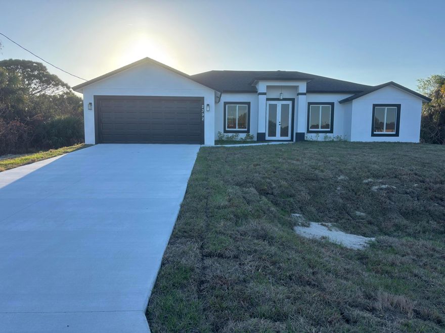 Beautiful Brand New Home, with over $50K in upgrades, 4/3/2, High Ceiling, coffer ceilings on great room and master bedroom, shower and jacuzzi on master bedroom, farm style sink, tiles throughout, granite countertops on kitchen and bathrooms, stainless steel appliances, Impact doors and windows, Impact glass front door and impact double rear French doors, back porch, great neighborhood, good schools and close to everything... a must see...Interior Photos from Identical model.. Color may vary..