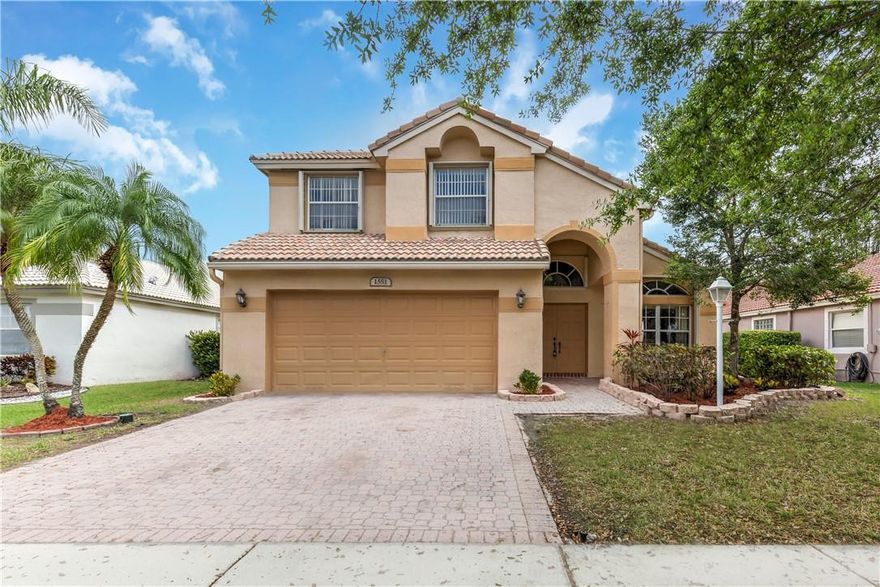 Bright, immaculate, and inviting freshly painted Malibu model with wide lake views.  Features include:  volume ceilings, gas stove and water heater that save on electricity, accordion shutters.  Huge backyard has plenty of room for a pool.   Master bedroom downstairs.  Maintenance fee includes basic cable, internet, and alarm.   Vibrant club house with banquet room, exercise room, resort style heated pool, jacuzzi, eight tennis courts and tons of classes.  Four manned guard gated entrances for easy access from many different roads.  Minutes to shopping and malls.   Sprinklers fed by lake water.