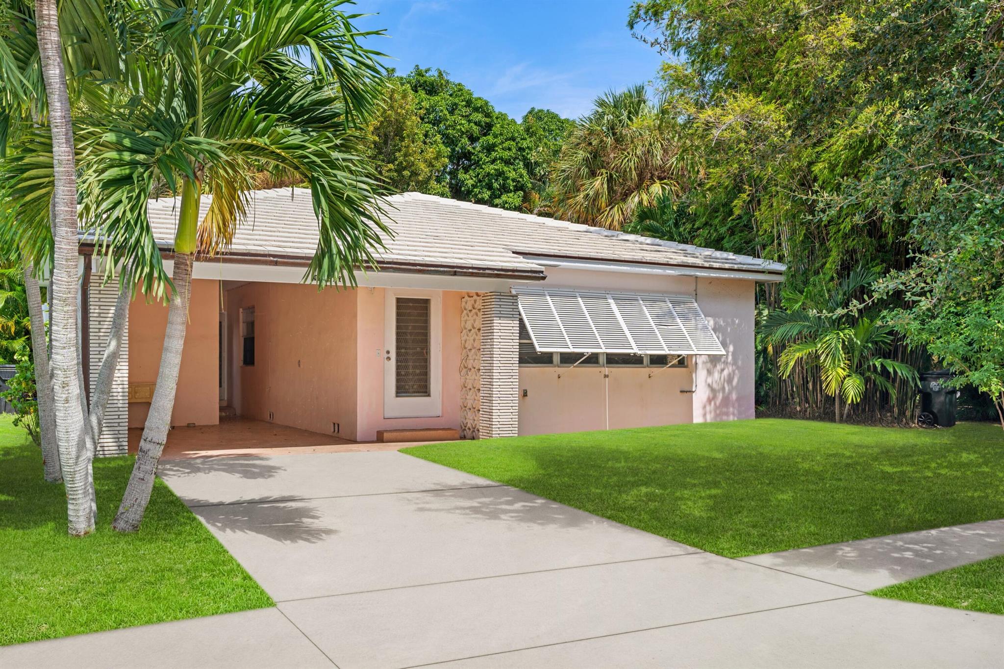 Public Remarks:Solid mid-century ranch style home, on a quiet cul-de-sac in southeast Lake Worth Beach. 2 bedrooms, and 2 baths, with a large living room, fireplace, and original oak floors. There are french doors leading out to the yard from the living room, and primary bedroom. The covered carport also has a laundry room, and covered rear entrance. The home is concrete block construction, the roof is concrete tile. There is room for a pool, and the carport could be made into a 1 car garage. The home can also be sold with the adjacent lot to the east, that is also for sale. The lot is listed separately for $375,000. The combined lot size is 100x117.