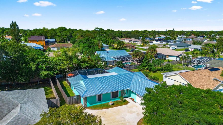 BRAND NEW METAL ROOF OCT. 2025! Discover unbeatable value in this spacious 4-5 bedroom pool home with private home office or in-law suite potential. You will love the low-maintenance stucco exterior, private screened-in pool & fully fenced backyard w/lush privacy landscaping--ideal for children, pets, and relaxing Florida living. Step inside to a bright, open floor plan with vaulted ceilings, neutral tile flooring throughout and a huge kitchen designed for entertaining--featuring a large island, dual sinks, newer Samsung appliances, a walk-in pantry & a glass pass-through to the Florida room w/French doors. The primary suite is your private retreat, showcasing a spectacularly renovated spa-like bathroom w/oversized shower, dual shower heads & luxurious porcelain marble tile.