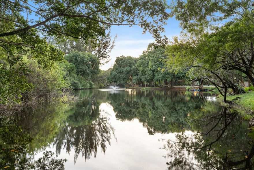 An extraordinary in-town retreat set across approximately 4.5 acres with a tranquil private lake, offering a rare blend of open land, natural beauty, and boundless potential. Discreetly positioned in the heart of Stuart, the property evokes a timeless countryside setting while remaining moments from everyday luxury. The existing CBS residence and expansive steel warehouse invite vision whether to restore, reimagine, or clear and create a custom farmhouse, modern estate, or generational family homestead. Wander from the quiet of your grounds to Downtown Stuart's waterfront dining, signature cafes, and boutique shops within minutes, or reach the Treasure Coast's most admired beaches with ease. Conveniently located near I-95 and the Florida Turnpike for seamless access throughout South FL.