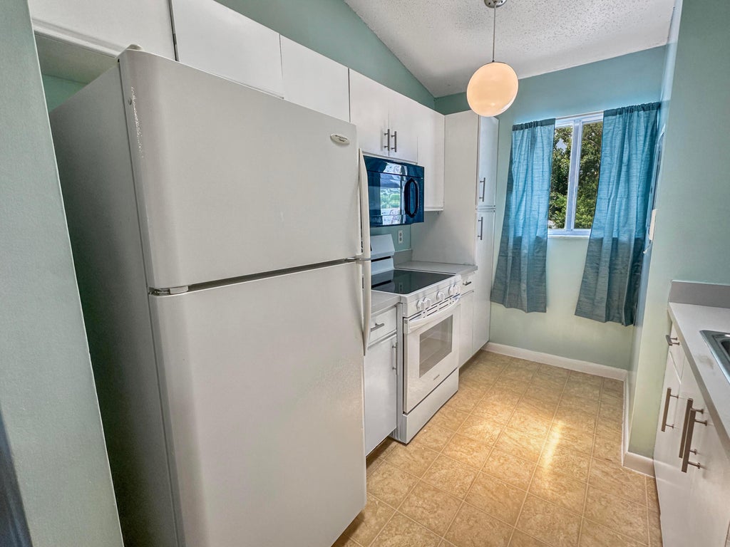 Photo of 5747 Deer Run Drive #1L, Fort Pierce, FL 34951 (MLS # B26074547)