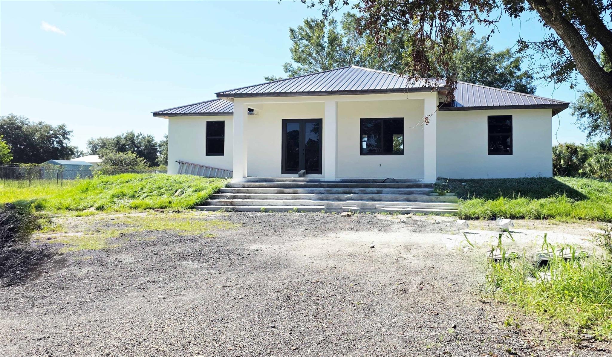 Check out this new construction in Montura Ranch Estate, Clewiston, FLORIDA, with 2025 sqft of Total Area.  This home features a modern design, with attractive design choices in flooring, cabinetry, granite countertops, lighting, and large impact windows that allow for natural light. Spacious living spaces, a great room plan, three bedrooms, and two bathrooms. The master bedroom will have a shower and bathtub, as well as a dual sink. The kitchen features stainless steel appliances and a granite countertop. A paved driveway, sweeping entry gate, and grand staircase are all elegant and tasteful. The home sits on a private, fenced 1.25-acre lot. Enjoy your private oasis. NO HOA REQUIRED. THE HOUSE IS EXPECTED TO BE COMPLETED BY October.