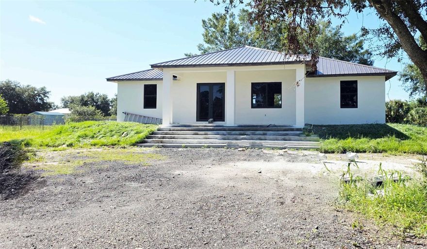 Check out this new construction in Montura Ranch Estate, Clewiston, FLORIDA, with 2025 sqft of Total Area.  This home features a modern design, with attractive design choices in flooring, cabinetry, granite countertops, lighting, and large impact windows that allow for natural light. Spacious living spaces, a great room plan, three bedrooms, and two bathrooms. The master bedroom will have a shower and bathtub, as well as a dual sink. The kitchen features stainless steel appliances and a granite countertop. A paved driveway, sweeping entry gate, and grand staircase are all elegant and tasteful. The home sits on a private, fenced 1.25-acre lot. Enjoy your private oasis. NO HOA REQUIRED. THE HOUSE IS EXPECTED TO BE COMPLETED BY October.