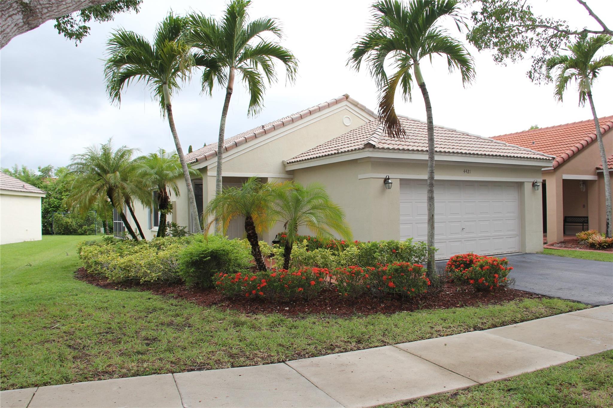 Welcome to The Ridges, a gated community in the heart of Weston. This one-story, 3 Bedroom, 2 Bathroom home sits on an irregular lot giving you an oversized side yard. The property sits on a quiet tree-lined street. The back of the home offers a screened in patio with lush landscaping. Master Bedroom is split from the other two bedrooms and offers a walk-in closet plus bathroom with frameless shower. Home features volume ceilings, wood laminate flooring, crown molding, and accordion hurrican shutters throughout. Kitchen features, granite countertops, stainless steel appliances, extended breakfast bar, and white cabinetry. Laundry in the 2 car garage. Community is gated with 24 hr guard gate. Community p[ool, clubhouse, kid's play areas, basketball, parks, and lots more.