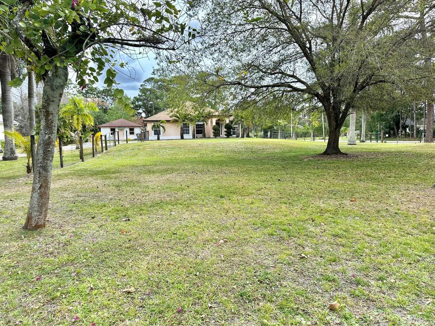 Centrally located in beautiful Jupiter Farms this unique CBS  home features 3 bedroom,2 baths,2 car garage plus  a 704 sq. ft. CBS  GUEST HOUSE.  Plenty of room for the whole family/ Main house is open & spacious/ Split bedroom plan/ Beautiful updated guest bath/ Huge enclosed Porch/ inside Laundry room / No pond/ Plenty of room for pool/
A/C 2019 / Roof 2018, Fully fenced 1.25 acres loaded with beautiful palm trees/ 2 separate septic tanks/- 1 for each building/2 sheds-1 with electric.  . 2 bedroom-1 bath GUEST HOUSE house was built in 2007/ new a/c 2023 / Property includes a John Deer Lawnmower, Generator, Freezer and extra Refrigerator/  Both septic tanks were cleaned out on 9/7/2023/ Main house- new refrigerator 9/16/2023.new garbage disposal 3/16/2023, Garage door serviced 9/7/2023 Taxes are based on no Homestead Exemption/ All sizes and data approx.   Sold as-is with right to inspect.
Property is also crossed fenced with 3- 12 foot gates.