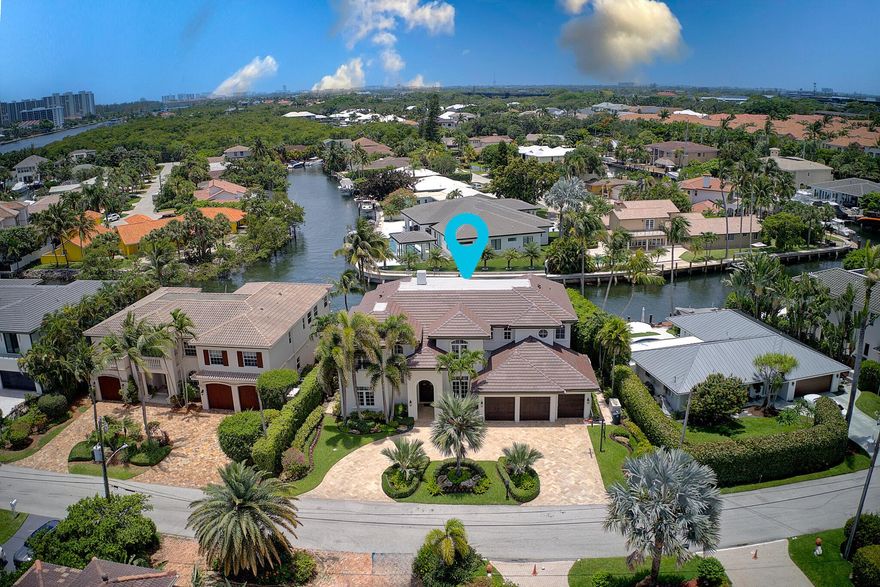 This magnificent deepwater showplace offers southern exposure and showcases modern contemporary design throughout. Built to the highest standards, it features hurricane impact glass, a full-house generator, elevator, and a spacious three-car garage. The residence includes five bedrooms, five and a half baths, plus a library, all impeccably maintained and presenting like new. Outdoor amenities include a summer kitchen, resort-style pool and spa, a 40,000-pound boat lift, and a large turning basin, making it ideal for boating enthusiasts.