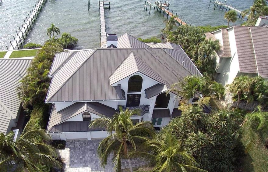 Stunning wide river views from this updated 4 bedroom, 4 bath home in desirable Joe's Point. Watch the sunrise from the community's private beach park then enjoy spectacular sunsets from the lanai, living room, master bedroom or 2nd floor balcony.  The kitchen features new cabinets and quartz countertops, a gas range and wine cooler.  All new flooring throughout and bathrooms updated too.  The office looks over the community lake directly in front of the home. New sea wall, refurbished pool, 10k boat lift, elevator and 2017 roof. This gated community features a small marina, RV and boat parking, tennis and pickleball in addition to the beach access.  You can have it all with this amazing home in Stuart.