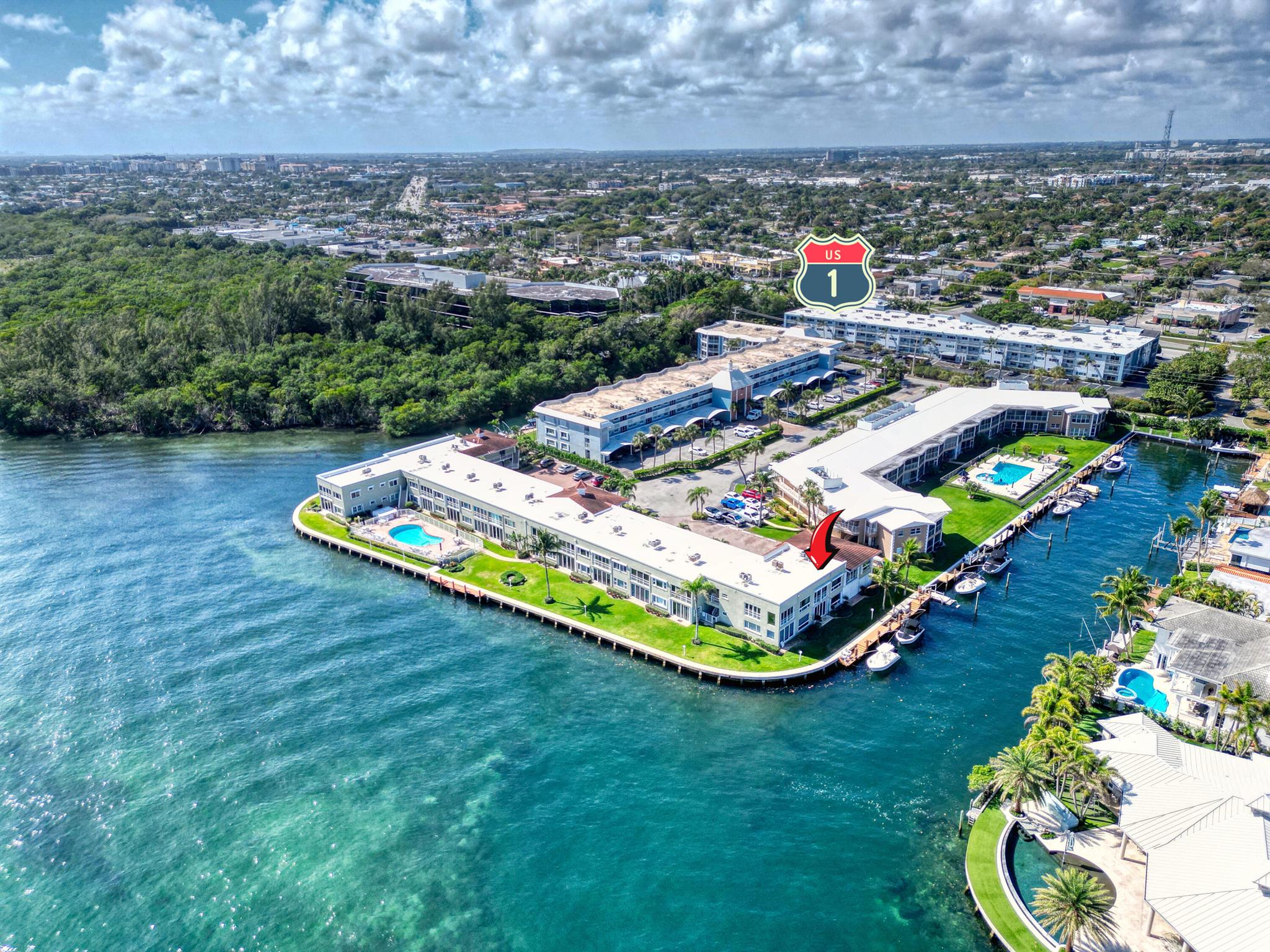 This waterfront modern beautifully updated turn key first floor corner unit has it all! Windows on three sides. Full size washer/dryer is in the unit, AC new in 2021. Automated blinds, This well maintained 30 unit condominium community with a waterfront heated pool encompasses the entire end of the peninsula fronting the Intracoastal and John B Rutherford Park. Convenient location by land and sea. Walk to Fifth Ave shops and more. Bike to the beach. Only about 1.5 miles to Mizner Plaza and 2 miles to the Boca Inlet by water. Come make this home your own!