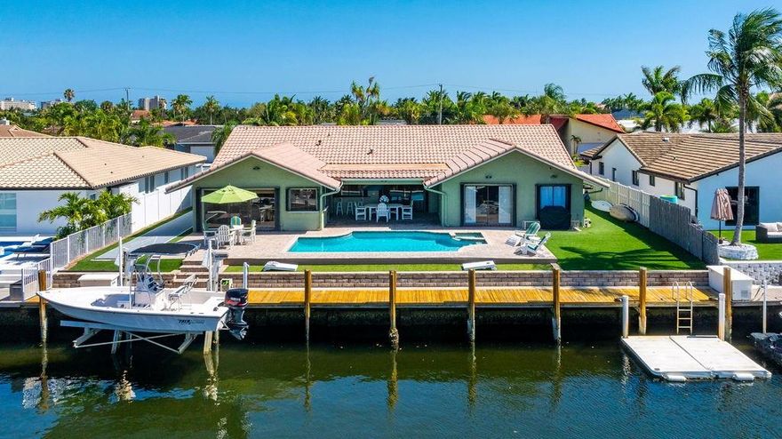 A Waterfront Gem in Lighthouse Point! This beautifully laid-out residence features 3 spacious beds, 2.5 bathrooms, and open, functional floor plan. From the foyer entry, you step into a large living and formal dining room. The tastefully updated, oversized kitchen is the heart of the home and leads to a huge family room perfect for entertaining. Split-stack BR layout providing privacy & comfort, with 2 rooms tucked behind a pocket door & a generous primary suite featuring 2 closets and spacious bath. Outside in the backyard oasis: a covered patio, resort-style pool, artificial turf.  85 feet of water, complete with 10K lb boat lift. Interior laundry room, 2 car garage. Quiet, tree-lined street with underground utilities. Don’t miss the opportunity to make this incredible property your own!