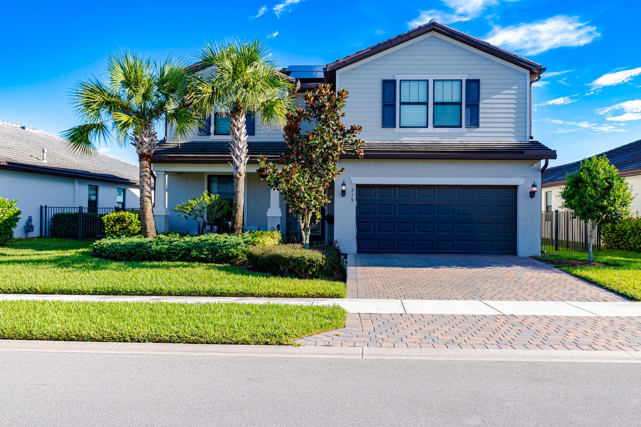 Veranda Gardens, 2-Story, DiVosta Citrus Grove Model has 4 bedrooms and 2.5 bathrooms plus flex room and is on the lake! This home offers a family friendly layout with large loft along with three bedrooms and full bath on second floor. Primary suite is on main level complete w/dual-sinks and large walk-in closet. Home features: Flex/Den/Office, extended island and built-in entertainment area in kitchen. Laundry room with cabinets and sink. Decorative railing on staircase. Screened-in covered extended patio offers gorgeous lake view, fenced yard with three gates and plenty of room for a pool. Bonus: Impact Glass windows and doors, glass front door, solar panels, Tesla wall charger in 4' extended garage, water filtration system and water softener. Some photos are virtually staged.