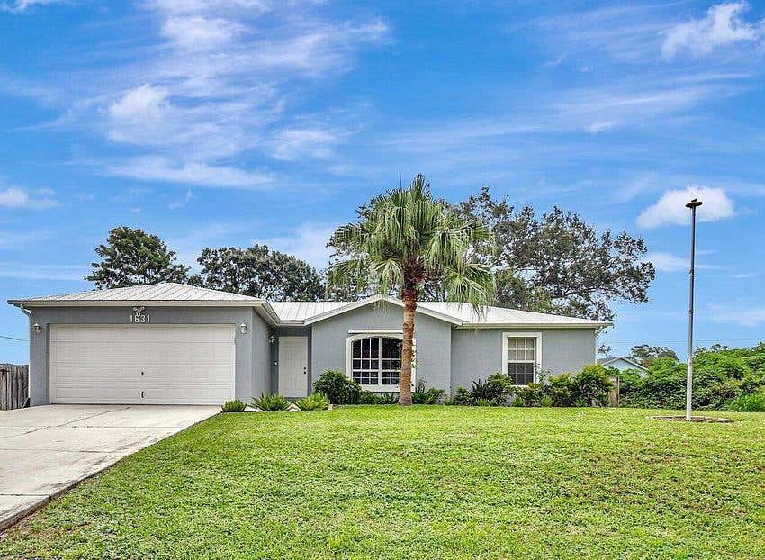 Photo of 1631 SW Norman Lane, Port Saint Lucie, FL 34984 (MLS # R11018238)