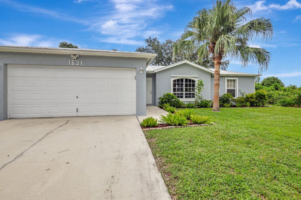 Photo of 1631 SW Norman Lane, Port Saint Lucie, FL 34984 (MLS # R11018238)