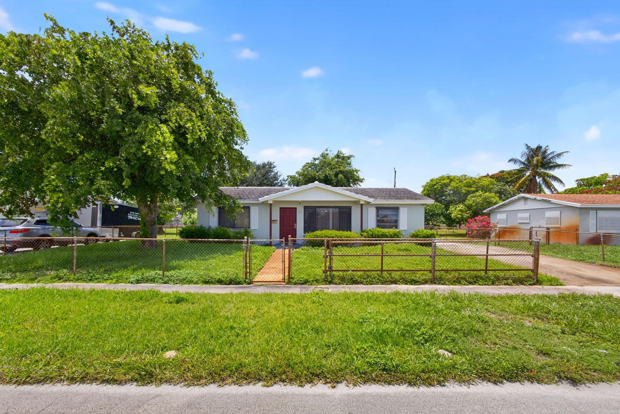 Three bedroom, two bath ''Dollhouse'' one mile from the beach and toes in the sand! Large backyard on canal buffer. Yard is fully fenced front & back and has plenty of room for a pool! Well water sprinkler system keeps the lawn green while the house enjoys city water inside. Also includes a 10 x 8 storage building. Home is CBS construction, the main living areas have tile floors, bedrooms have wood laminate; however, entire house slab is terrazzo! Huge kitchen/dining area for gatherings opens to a covered 10 x 8 patio for entertaining, BBQ, etc. Natural gas water heater and gas oven/range for the gourmet chef. Follow Blue Heron Blvd across US1 which becomes Jimmy Buffet Memorial Hwy and provides access to multiple beach locations, fishing, paddleboard, boating, restaurants, more! Enjoy!