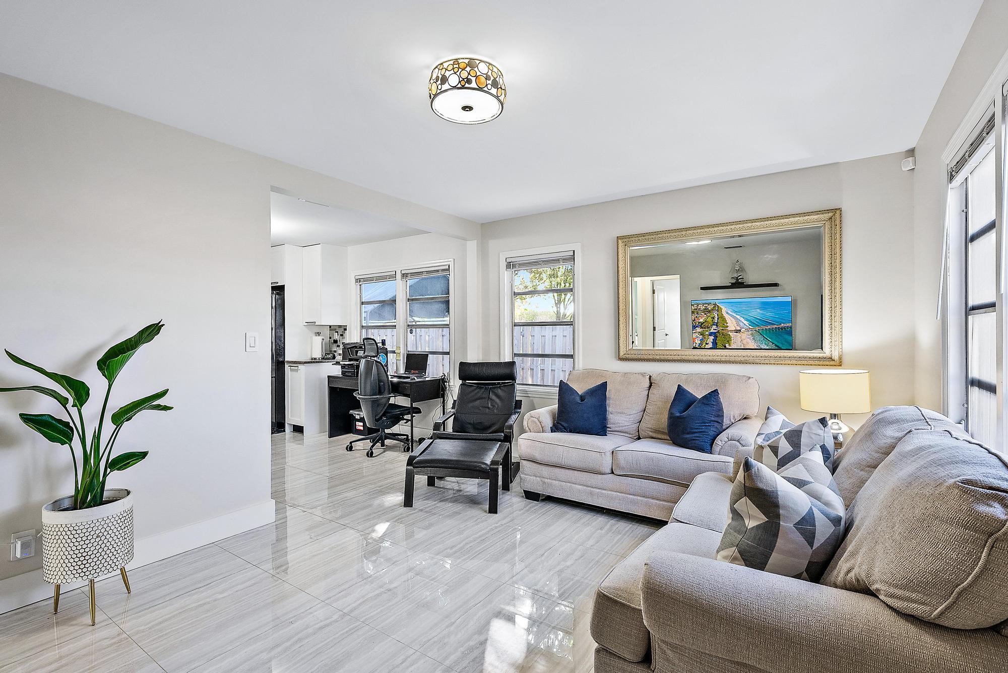 8 blocks from the Intracoastal Waterway in coastal West Palm Beach on a tree - lined street. Meticulously renovated and completed in 2020. Super clean and plenty of windows for natural light. It features new walls, porcelain tile floors and Quartz bathroom floors, Quartz kitchen countertops, black stainless-steel appliances, stackable washer and dryer, electric water heater, newly installed 2018 shingle roof, off-street driveway parking with plenty of space for cars, boat, or RV.