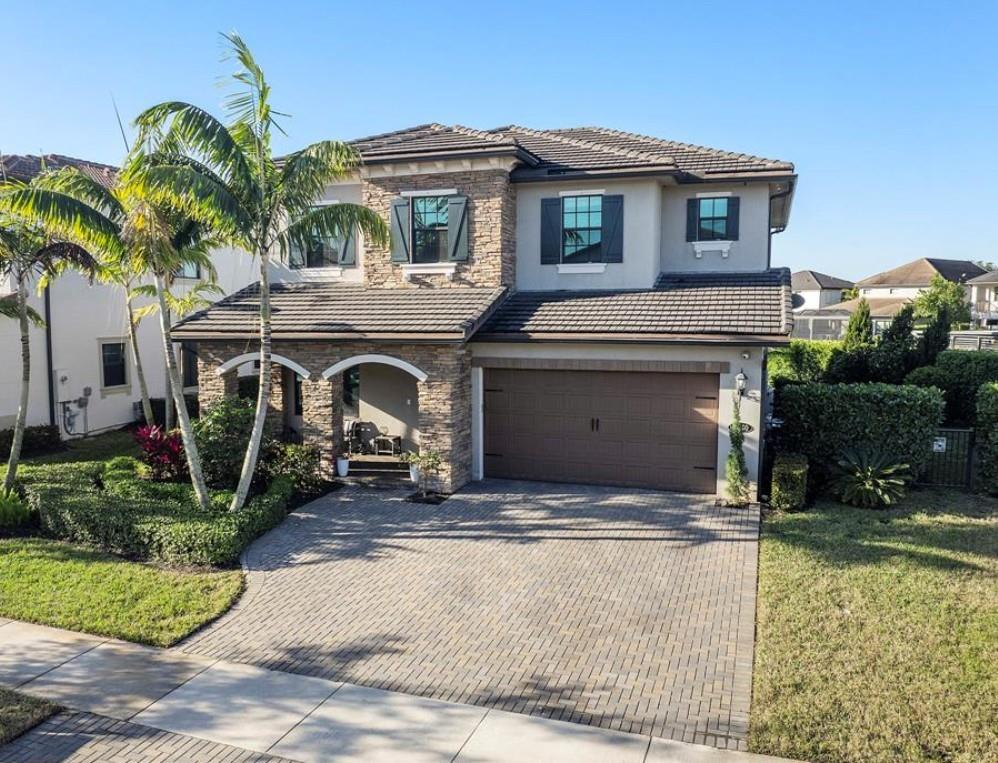 Spectacular 5 Bed & 4 Baths Home in Watercrest, ONLY 8 yrs old. Pretty long lake oversized lot & garden on one side. Heated salt water pool & spa with beach tanning shelf & umbrella anchor for shade & LED lighting. So many upgrades and details! Real wooden flooring & Italian Tile, Kitchen Aide stainless appliances, double ovens & Samsung smart refrigerator w/Alexa and WIFI stock hub. Quartz countertop island & breakfast bar, huge walk-in pantry designed by Closet Factory, Walnut kitchen cabinets with real stone backsplash & 2 matching accent stone TV walls w/ decorative remote fireplace. Open floor plan with tons of family space. Impact windows, doors & garage door. Custom designed Garage.  A Generator that fuels the entire home if you lose power. Central Vacuum System. Graded A+ Schools