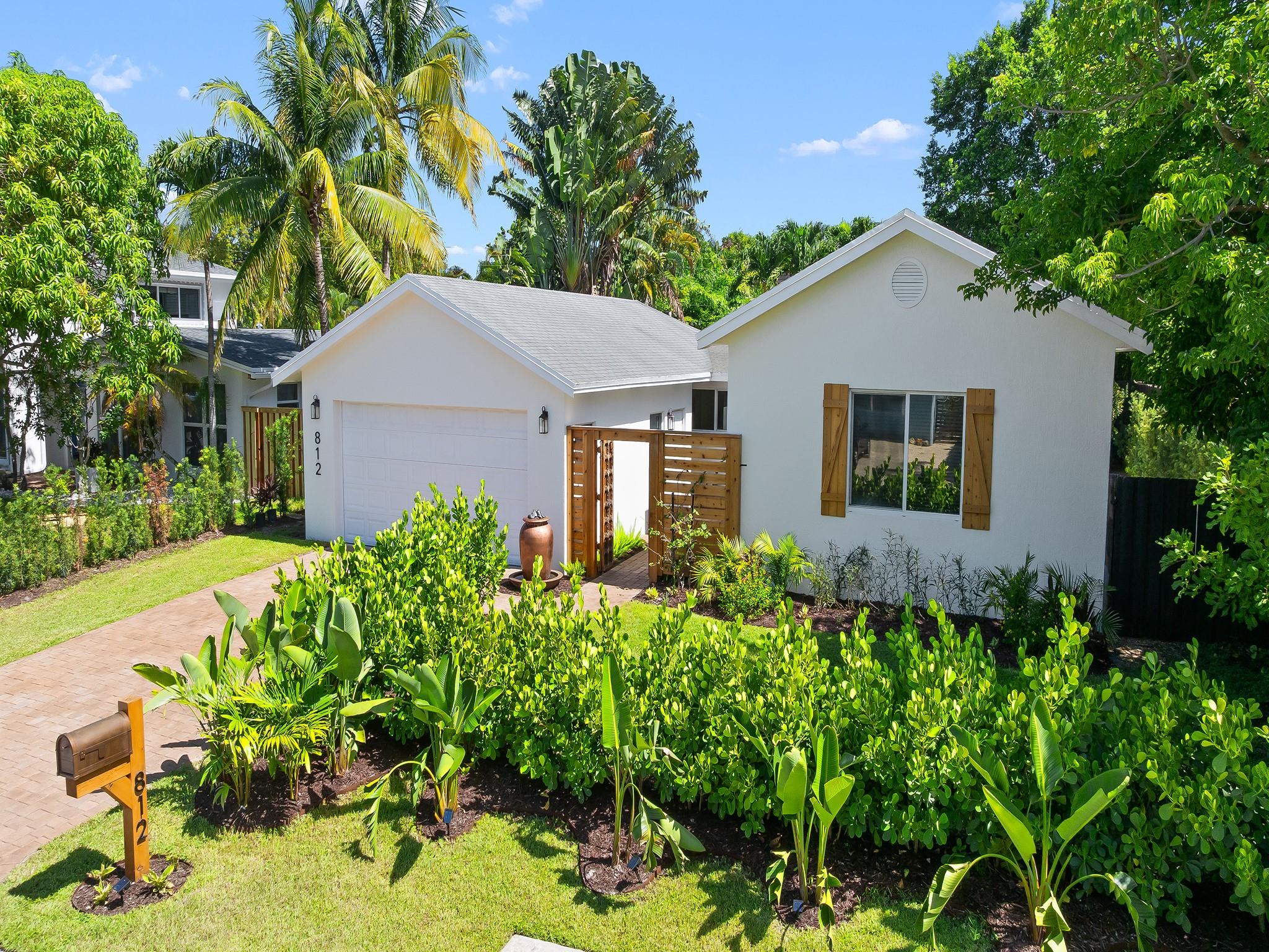 1957, meet 2025. Renovated 2BR/2BA pool home + two-car garage in Wilton Manors West. Antique wooden doors open to a planted courtyard at this mid-century classic. Inside are contemporary design elements such as a massive open living space, large impact windows and doors and high-end finishes throughout. The kitchen includes loads of custom cabinets, walk-in pantry and laundry room. The primary suite (former 3rd BR) spans the width of the house and includes a make-up and vanity area, en suite bath, office space, French doors to the pool deck and polished concrete floors. Mature poolside trees provide shade and sun outside year round. Sunny, roomy guest room and second full bath. All wiring is copper; all plumbing is PVC. Easy access to Wilton Drive, Downtown FTL, beaches and freeways.