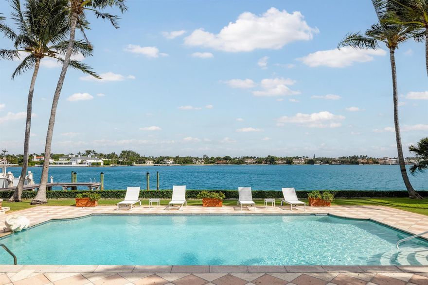 A remarkable and rare opportunity! This beautiful lakefront estate is nestled on an exceptional, oversized, east-facing lot on the coveted Everglades Island. Originally designed by renowned society architect Marion Sims Wyeth, the home features 7 bedrooms, 6 bathrooms, and 1 powder room, spectacular wide water views from nearly all main rooms, and boasts 175 +/- feet of direct Intracoastal frontage. Formal living room with fireplace opens to expansive, light-filled interior loggia that overlooks the swimming pool. Eat-in kitchen with large island and breakfast bar. Formal dining room with charming bay window. Breakfast room with beamed ceilings and pocket doors on either side for plenty of natural light. Paneled library with built-ins. Primary suite with large bath, dressing room, walk-in