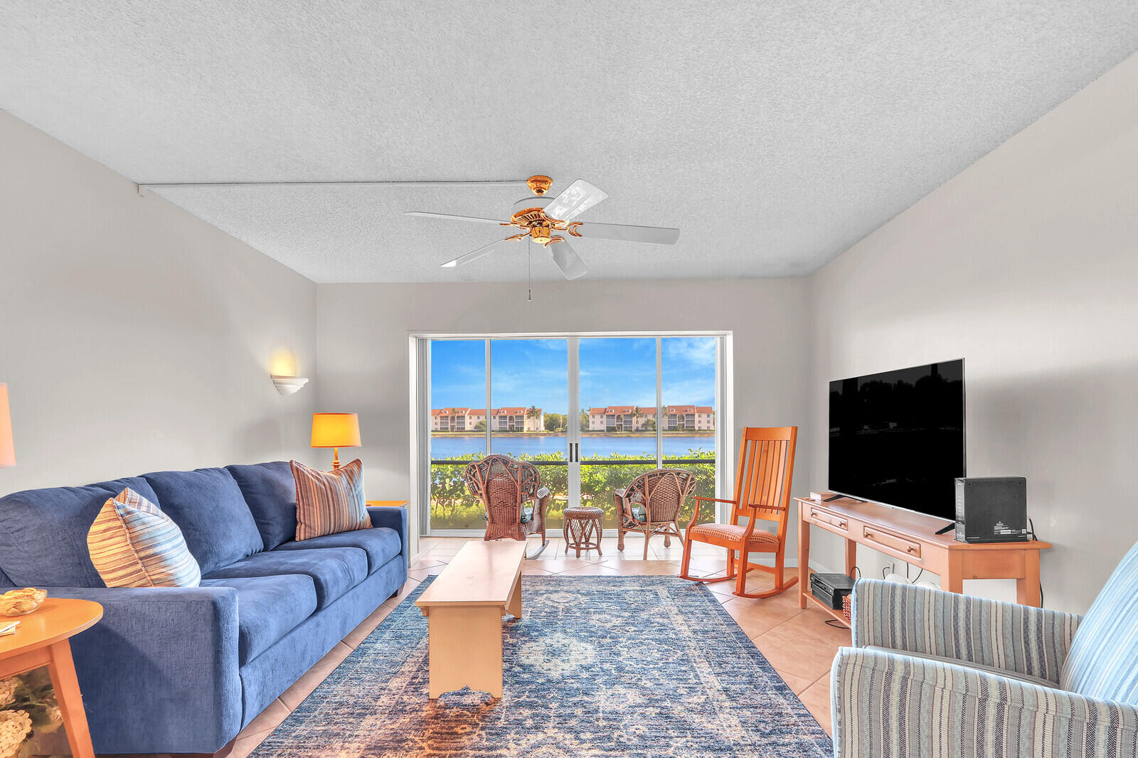 Winter Paradise awaits you **DIRECTLY ACROSS THE STREET FROM THE OCEAN** is this GATED, fully furnished, wonderful, clean, turnkey, first floor lake view 2/2 condo with screened in private lanai. Amenities include a stocked 7 acre fresh water lake for fishing, two hard surface lighted tennis courts, bocce, shuffleboard, heated swimming pool, adjacent spa and community clubhouse. In the heart of the Island this location offers fabulous restaurants, shopping, and beautiful beaches. Cable is included. Free WIFI is available in the Unit and at the clubhouse along with flat screen HD TV for our community enjoyment. The active social calendar boasts activities for everyone.