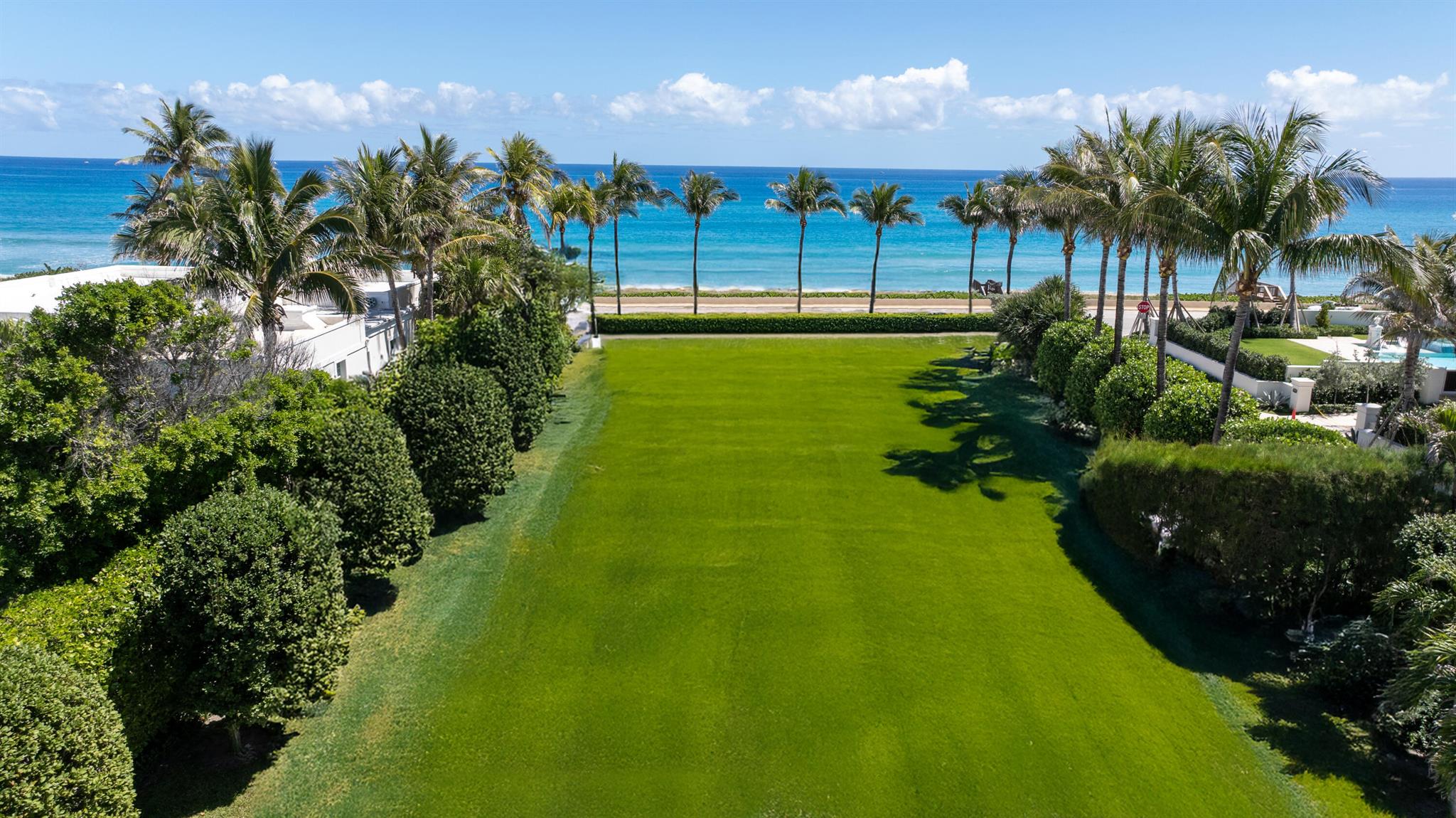 Situated in Palm Beach's prestigious Estate Section, this exceptional oceanfront parcel presents a rare opportunity to build on a unique corner lot with beachfront access on Billionaire's Row. Spanning approximately 3/4 of an acre, the property offers panoramic views of the Atlantic Ocean. The beach parcel, measuring approximately 10,000 sq feet (101 x 90 x 96 x 101 feet), features a private beach deck and direct access to the sand. Currently, the site includes a fully renovated, modern beach house with premium finishes throughout, complete with 4 bedrooms and 4.5 bathrooms in the main residence, plus an additional bedroom and bathroom in the detached cabana guest house. 1740 S Ocean Blvd combines location and ultimate land value, offering rare frontage and elevated privacy in Palm Beach!