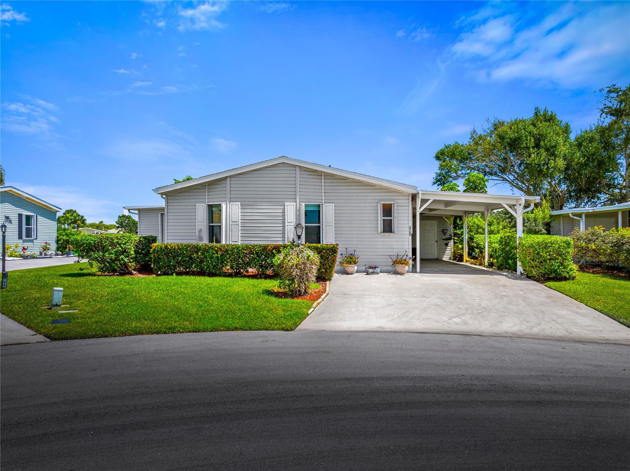 Beautiful water views! Must see! Well kept TRIPLE-wide 2001 modular home with BRAND NEW AC in the Preserve at Savanna Club, a vibrant 55+ golf community. This 2-Bed/2-Bath residence with peaceful lakefront views features an open floor plan plus a versatile Florida room ideal for crafts or home office space. Situated on a prime cul-de-sac with a large carport and an outdoor storage. Extras include hurricane shutters and a well system for garden irrigation. Resort-style amenities include an 18-hole golf course, fitness center, and multiple clubhouses with exciting year-round social events. Conveniently located near beaches, shopping, dining, and entertainment. Please allow 72 hours for seller response. No site-unseen offers will be considered.