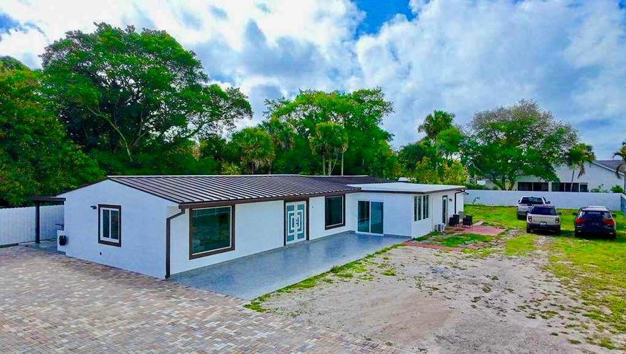 BEAUTIFUL HOME!! 4 bedrooms and 2 bathrooms, this property offers a spacious backyard with lush avocado trees, fully fenced for privacy.  Enjoy your mornings on the open porch with a relaxing cup of coffee.  The home includes a Brand New Metal Roof (2025) and impact windows and doors for added durability and peace of mind. Ideally located near major highways, beaches, City Place, and more, this property offers both comfort and convenience. Don't miss this incredible opportunity to make this house your Home!